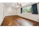 A spacious living room features hardwood floors, ceiling fan, with a window providing natural light and beautiful backyard views at 4290 Chestnut Grove Ln, Austell, GA 30106