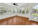Bright sunroom featuring large windows, a ceiling fan, and hardwood floors at 4290 Chestnut Grove Ln, Austell, GA 30106