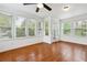 Bright sunroom featuring large windows, a ceiling fan, and hardwood floors at 4290 Chestnut Grove Ln, Austell, GA 30106
