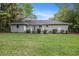 The backyard features a lush lawn and a deck perfect for outdoor entertaining at 5052 W Mountain St, Stone Mountain, GA 30083