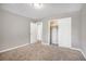 This cozy bedroom features neutral walls, carpet, and a closet for storage at 5052 W Mountain St, Stone Mountain, GA 30083