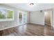 Living area with French doors leading to outdoor space, bright windows, and wood floor at 5052 W Mountain St, Stone Mountain, GA 30083