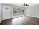 Bright living room featuring wood floors, large windows, and a modern ceiling fan at 5052 W Mountain St, Stone Mountain, GA 30083