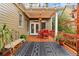Charming back porch area featuring an outdoor dining set, stylish decor, and a cozy atmosphere at 963 Manor Parc Dr, Decatur, GA 30033