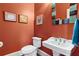 Charming half bathroom with vintage-style sink, decorative mirror, and vibrant color at 963 Manor Parc Dr, Decatur, GA 30033