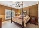 Comfortable bedroom with a canopy bed, neutral carpet, and a window view of the exterior landscape at 963 Manor Parc Dr, Decatur, GA 30033