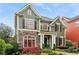 Charming two-story home with stone accents, red framed windows, lush landscaping and inviting curb appeal at 963 Manor Parc Dr, Decatur, GA 30033
