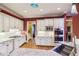 Modern kitchen with stainless steel appliances, granite countertops, white cabinets, and a view of the hallway at 963 Manor Parc Dr, Decatur, GA 30033