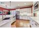 Modern kitchen featuring white cabinetry, stainless steel appliances, granite countertops, and hardwood flooring at 963 Manor Parc Dr, Decatur, GA 30033