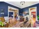 Spacious living room showcasing hardwood floors, classic blue walls, and seamless flow to other rooms, ideal for entertaining at 963 Manor Parc Dr, Decatur, GA 30033