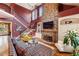 Cozy living room features a stone fireplace, built-in shelving, hardwood floors, and staircase at 963 Manor Parc Dr, Decatur, GA 30033