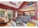 Open living room with high ceilings, a modern sectional sofa, and large windows providing ample natural light at 963 Manor Parc Dr, Decatur, GA 30033