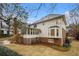 Spacious backyard featuring mature trees, and a covered patio area off the back of the house at 1122 Manning Farms Ct, Atlanta, GA 30338