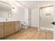 This bathroom has wood flooring, a modern vanity, and a shower with a glass enclosure at 1122 Manning Farms Ct, Atlanta, GA 30338