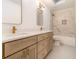 A bathroom with a double sink vanity, modern fixtures, and marble-tiled shower and tub at 1122 Manning Farms Ct, Atlanta, GA 30338