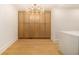 Bright room with blonde wood floors featuring a modern chandelier and built in cabinets at 1122 Manning Farms Ct, Atlanta, GA 30338