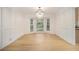 Elegant dining room with large bay windows, white paneling, and a modern chandelier at 1122 Manning Farms Ct, Atlanta, GA 30338