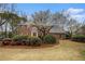 Charming two-story brick home with a well-manicured lawn and mature landscaping, including a flowering tree at 1122 Manning Farms Ct, Atlanta, GA 30338