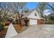 Two-story home featuring brick and siding with a two-car garage and well-manicured landscaping at 1122 Manning Farms Ct, Atlanta, GA 30338
