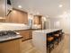 Modern kitchen featuring a large island with seating, stainless steel appliances, and light wood cabinetry at 1122 Manning Farms Ct, Atlanta, GA 30338