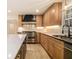 Updated kitchen with stainless steel appliances, granite counters, a white tile backsplash, and light wood cabinets at 1122 Manning Farms Ct, Atlanta, GA 30338