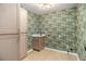 Bright laundry room with patterned wallpaper, wood floors, and storage cabinets at 1122 Manning Farms Ct, Atlanta, GA 30338