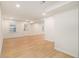 A spacious living room featuring vinyl floors, white walls, and an exterior door at 1122 Manning Farms Ct, Atlanta, GA 30338