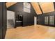 Stunning living room with hardwood floors, a wet bar, and vaulted ceilings with wood beams at 1122 Manning Farms Ct, Atlanta, GA 30338