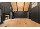 Elegant living room with black walls, a wood ceiling, built-in bookshelves, and a cozy fireplace at 1122 Manning Farms Ct, Atlanta, GA 30338