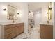Beautiful main bathroom featuring dual vanities and a glass enclosed shower with marble tile at 1122 Manning Farms Ct, Atlanta, GA 30338
