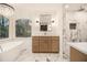 Elegant main bathroom features a soaking tub, shower with herringbone tile, and dual vanities at 1122 Manning Farms Ct, Atlanta, GA 30338