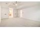 Bright main bedroom featuring a ceiling fan with tray ceiling, and closet and bathroom access at 1122 Manning Farms Ct, Atlanta, GA 30338