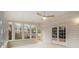 Bright sunroom with white walls, multiple windows, a ceiling fan, and tiled floors at 1122 Manning Farms Ct, Atlanta, GA 30338