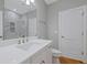 Bathroom featuring a vanity with a white countertop, undermount sink, and a walk-in shower with marble surround at 1857 Derrill Dr, Decatur, GA 30032
