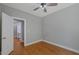 This bedroom features hardwood floors, ceiling fan, and a doorway to the ensuite bathroom at 1857 Derrill Dr, Decatur, GA 30032