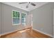Bright bedroom with hardwood floors, ceiling fan, and large windows overlooking the exterior at 1857 Derrill Dr, Decatur, GA 30032