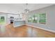 Well-lit dining area with view of the modern kitchen and backyard at 1857 Derrill Dr, Decatur, GA 30032