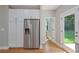 Kitchen boasts stainless steel refrigerator with water dispenser, ample cabinet space, and wood flooring at 1857 Derrill Dr, Decatur, GA 30032