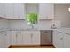 Modern kitchen featuring marble countertops, stainless steel dishwasher, and white subway tiles at 1857 Derrill Dr, Decatur, GA 30032