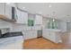 Open kitchen with modern appliances, white cabinets, and marble countertops at 1857 Derrill Dr, Decatur, GA 30032