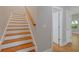 The staircase with hardwood stairs and white risers leads to the upper level of the home at 1857 Derrill Dr, Decatur, GA 30032