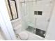 Bathroom with tiled shower stall with glass doors and matching black tile accents at 4579 Glenforest Ne Dr, Roswell, GA 30075