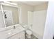 Bathroom vanity features white countertop, illuminated mirror, and modern faucet, as well as a tub at 4579 Glenforest Ne Dr, Roswell, GA 30075