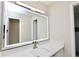 Bathroom vanity features white countertop, illuminated mirror, and modern faucet at 4579 Glenforest Ne Dr, Roswell, GA 30075
