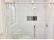 Bathroom with tiled shower stall with glass doors and matching black tile accents at 4579 Glenforest Ne Dr, Roswell, GA 30075