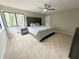 This bedroom features two windows, neutral carpet, and a decorative headboard and comforter at 4579 Glenforest Ne Dr, Roswell, GA 30075