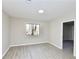 Bedroom featuring wood-look flooring and large window with natural light at 4579 Glenforest Ne Dr, Roswell, GA 30075