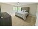 This bedroom features two windows and a decorative headboard and comforter at 4579 Glenforest Ne Dr, Roswell, GA 30075