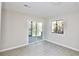 Bright bedroom features new floors, a sliding glass door to the deck, and a wooded view from the window at 4579 Glenforest Ne Dr, Roswell, GA 30075