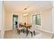 Dining room with modern light fixture, panelled walls, and hardwood floors at 4579 Glenforest Ne Dr, Roswell, GA 30075